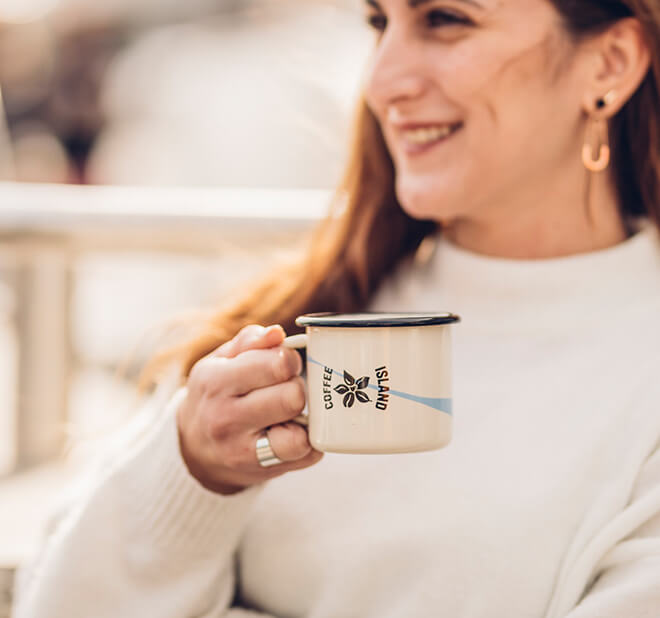 Woman holding coffee.  For those of you looking for an uncompromising taste in your decaf, choose Silent Breeze or Caramel Breeze, 99.9% decaffeinated with a non solvent based process!  Make your own decaf at home, and enjoy any time of the day! 
